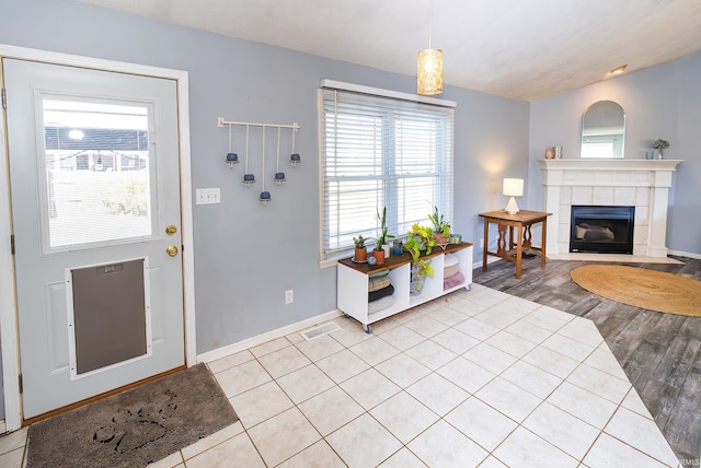 entrance foyer featuring light hardwood / wood-style flooring and a fireplace