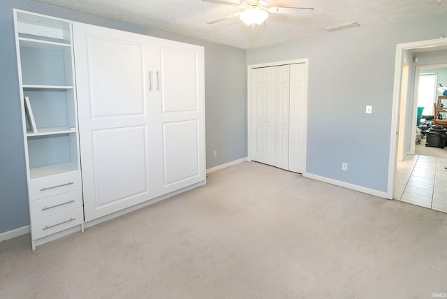 unfurnished bedroom with light colored carpet and ceiling fan