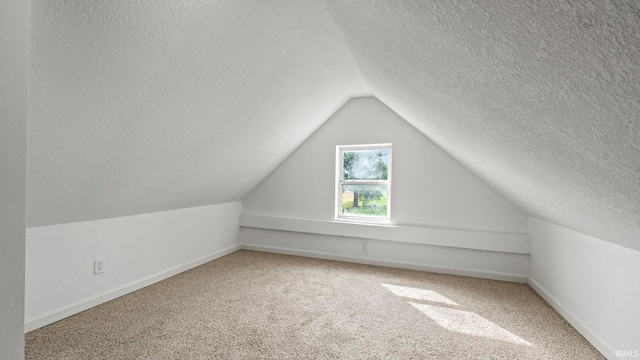 additional living space with a textured ceiling, carpet, and vaulted ceiling