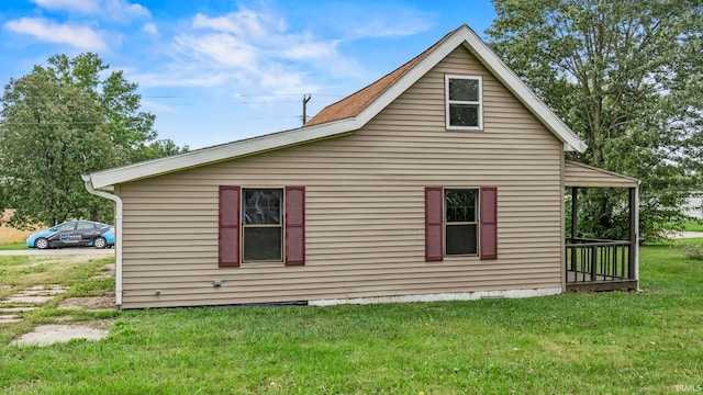 view of side of property with a yard