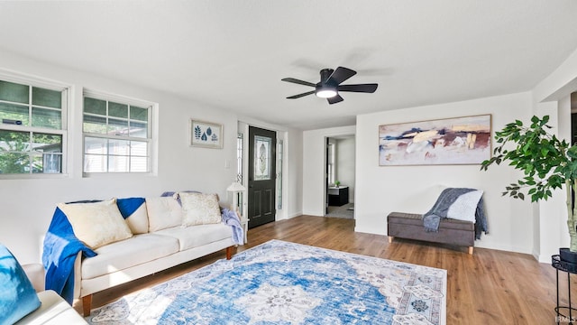 living room with wood-type flooring and ceiling fan