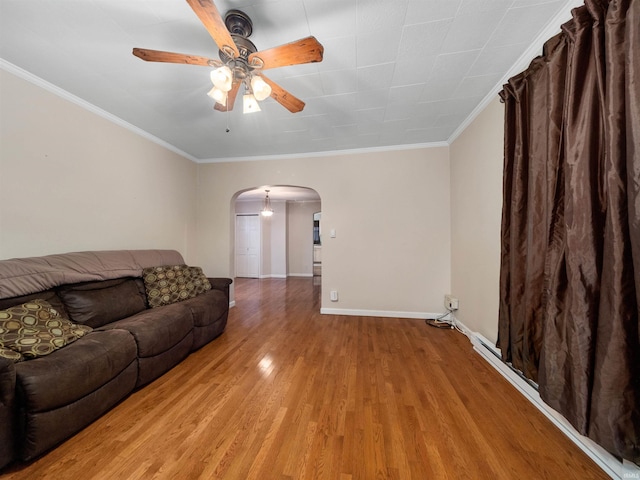 living room featuring light hardwood / wood-style flooring, ceiling fan, and ornamental molding