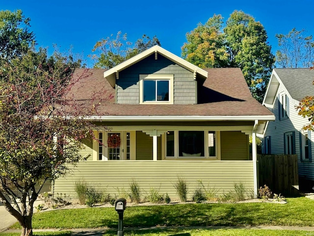 view of front of home featuring a front yard and a porch