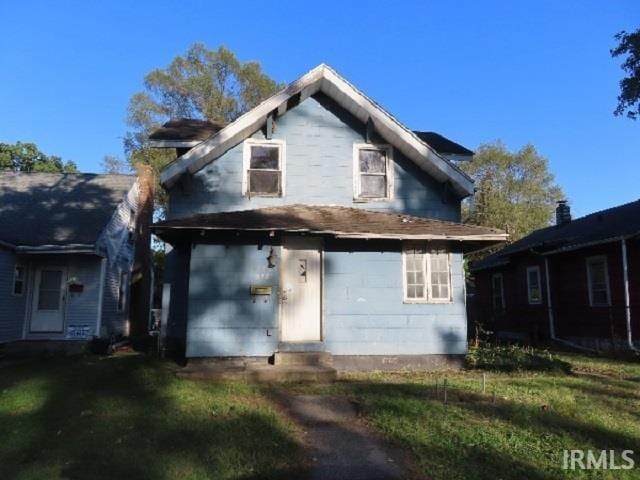 back of property featuring a lawn