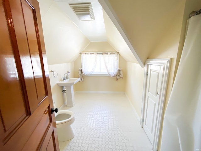 bathroom featuring visible vents, baseboards, toilet, and lofted ceiling