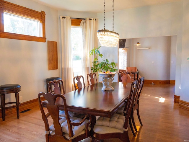 dining room featuring light hardwood / wood-style floors and a chandelier