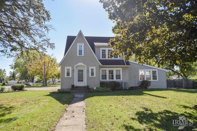 view of front of house with a front yard and central air condition unit