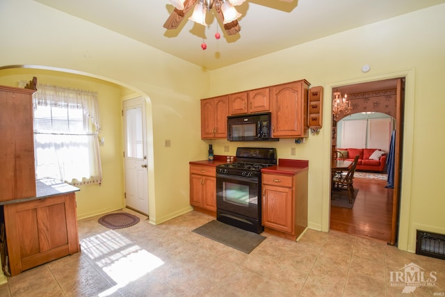 kitchen featuring light wood-type flooring, black appliances, and ceiling fan