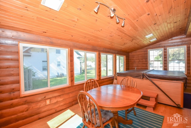 dining space featuring light hardwood / wood-style floors, wood ceiling, lofted ceiling, and rustic walls