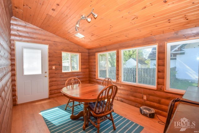 dining area with light wood-type flooring, vaulted ceiling, wooden ceiling, and log walls