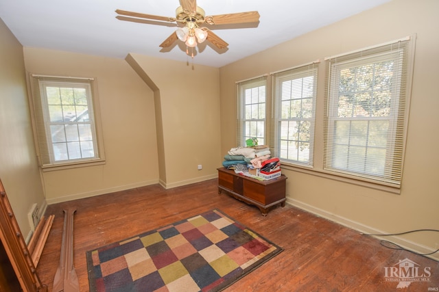 interior space with dark hardwood / wood-style flooring and ceiling fan