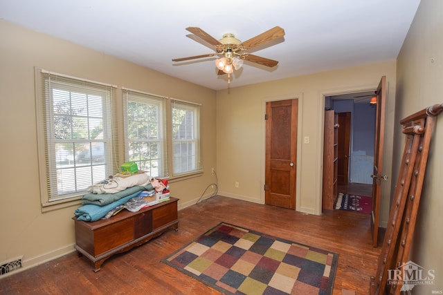 interior space featuring ceiling fan and dark hardwood / wood-style flooring