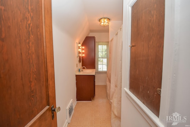 bathroom with vanity and a shower with shower curtain