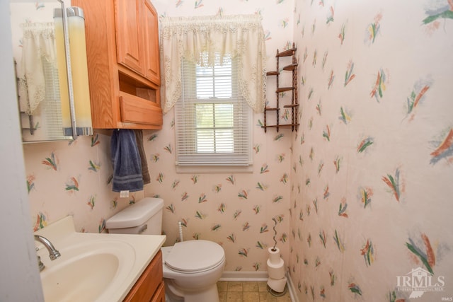 bathroom featuring tile patterned floors, vanity, and toilet