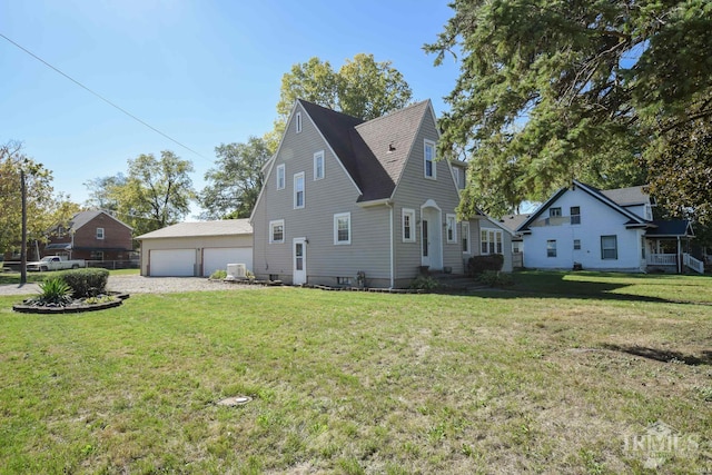 view of side of property featuring a yard and a garage