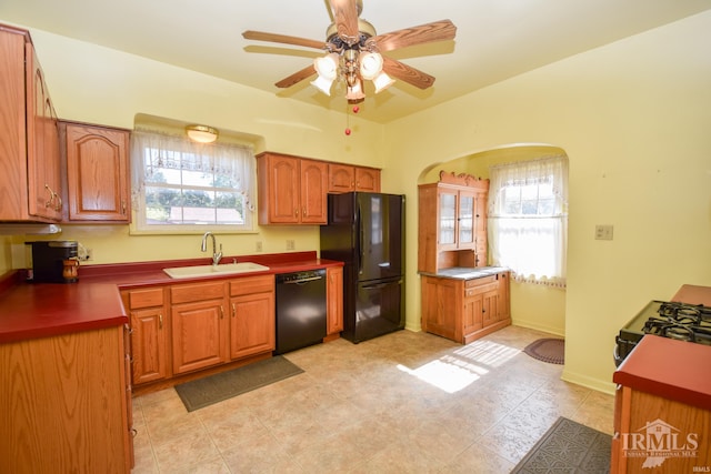 kitchen with a wealth of natural light, black appliances, ceiling fan, and sink