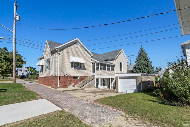 view of front of property with a front yard and a garage