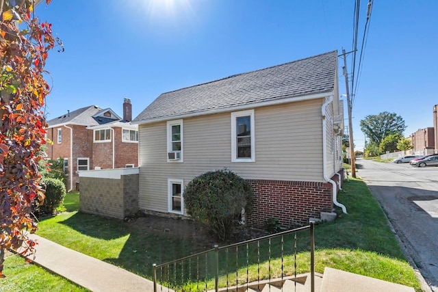 view of side of property with a yard