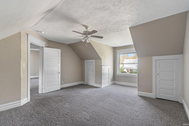 additional living space with lofted ceiling, carpet, a textured ceiling, and ceiling fan