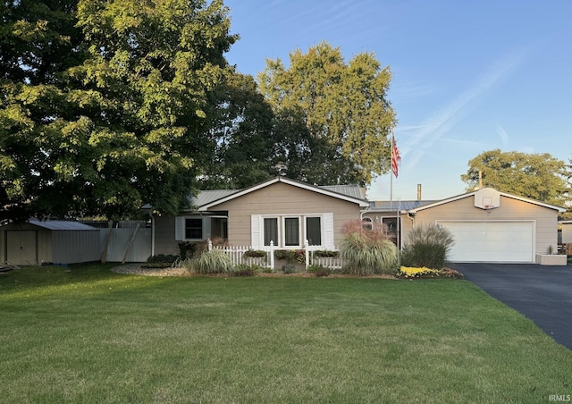 single story home with a garage and a front lawn