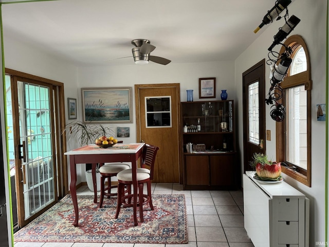 dining area with ceiling fan and light tile patterned flooring