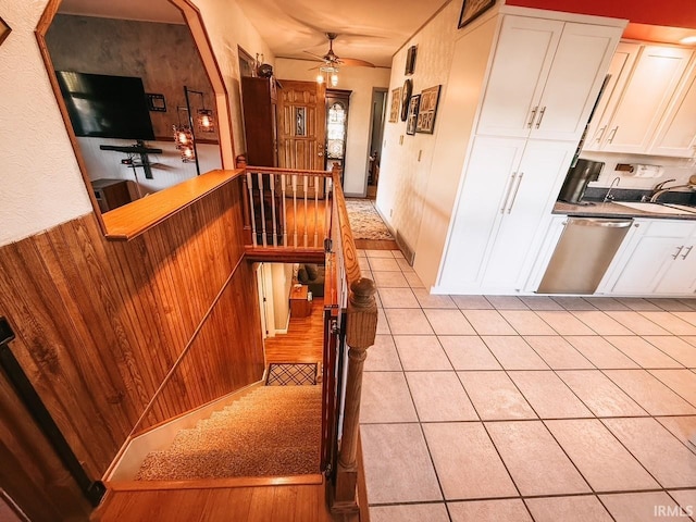 interior space with wooden walls and light tile patterned floors