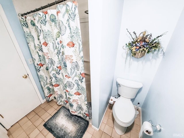 bathroom with tile patterned flooring, curtained shower, and toilet