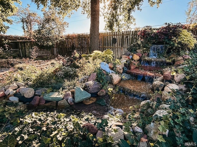 view of yard featuring a small pond