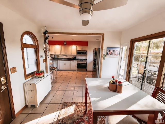 kitchen featuring appliances with stainless steel finishes, ceiling fan, light tile patterned floors, and sink