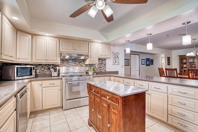 kitchen with light tile patterned flooring, stainless steel appliances, pendant lighting, decorative backsplash, and ceiling fan