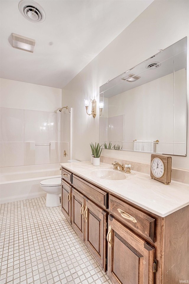 full bathroom featuring toilet, vanity, and tiled shower / bath