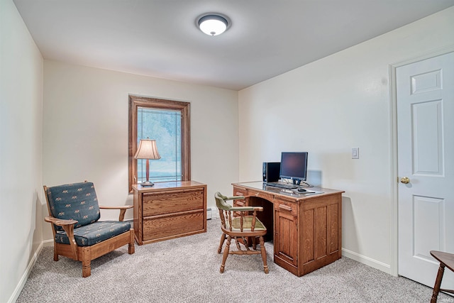 carpeted office featuring a baseboard heating unit