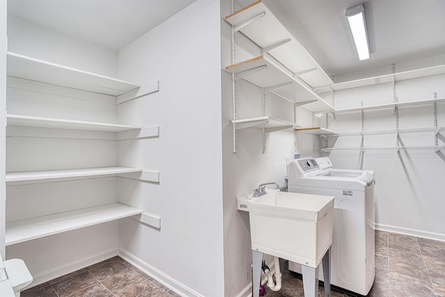 washroom with washing machine and clothes dryer and sink