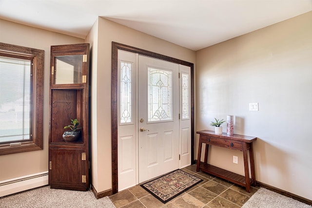 foyer entrance with a baseboard heating unit