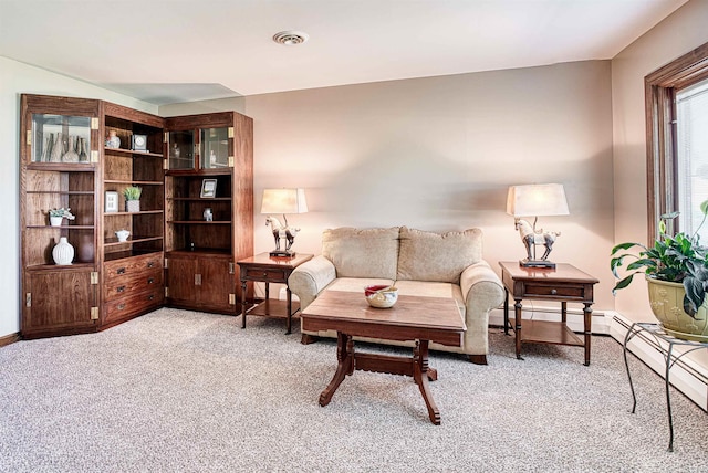 sitting room featuring a baseboard radiator and light carpet