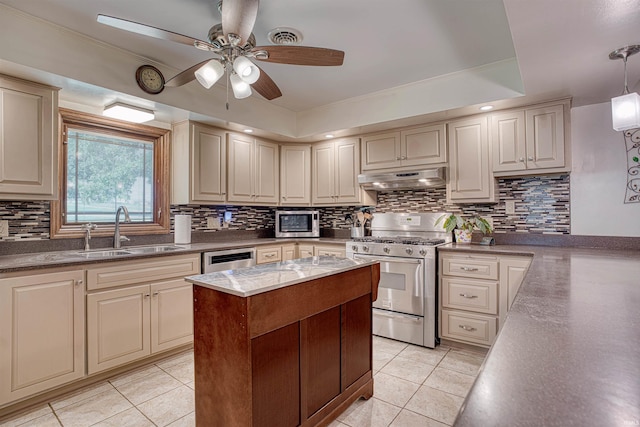 kitchen with appliances with stainless steel finishes, hanging light fixtures, sink, and light tile patterned floors