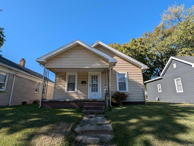 bungalow-style home with covered porch and a front yard