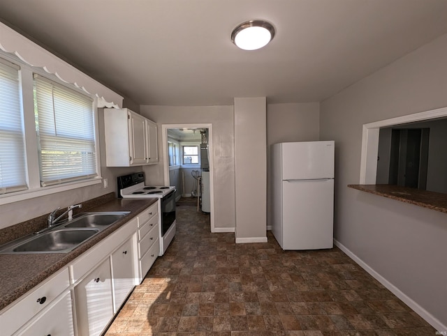 kitchen with white appliances, sink, and white cabinets