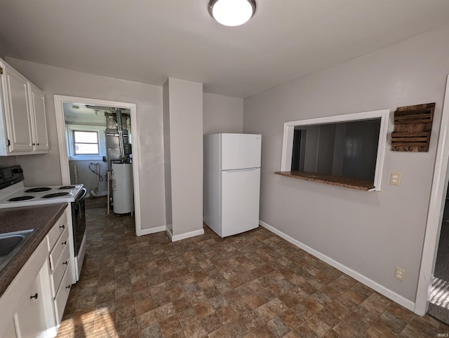 kitchen featuring gas water heater, white appliances, and white cabinetry