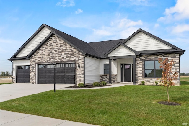 craftsman house featuring a front yard and a garage