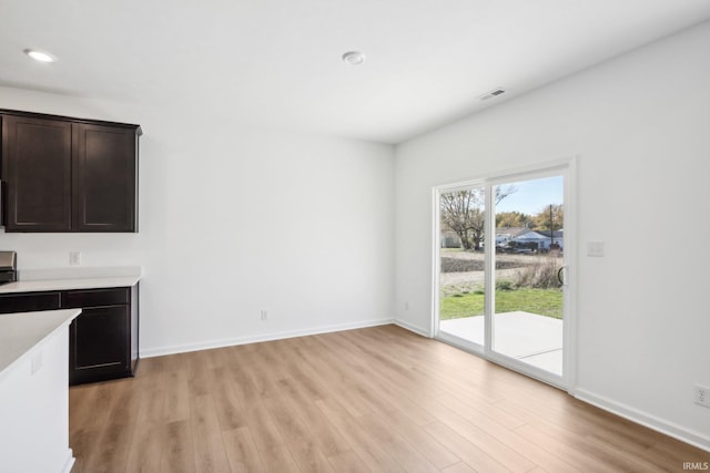 unfurnished dining area with light wood-type flooring