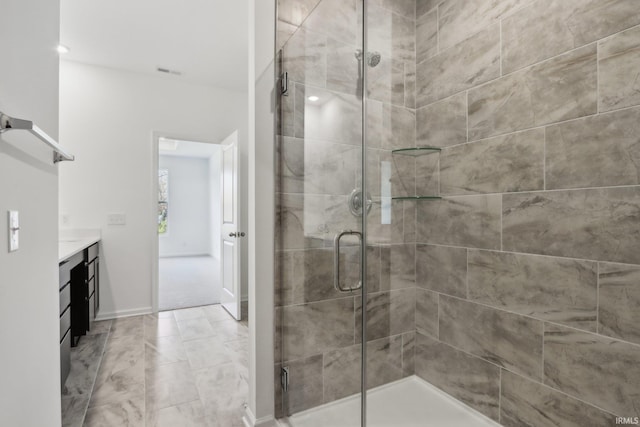 bathroom featuring vanity and a shower with door