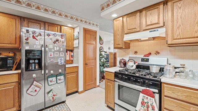 kitchen with backsplash and appliances with stainless steel finishes