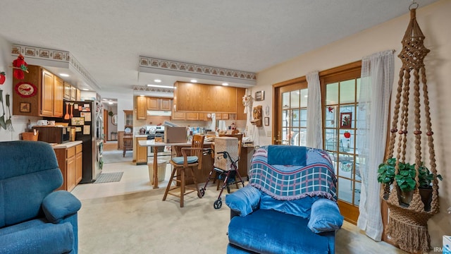 carpeted living room featuring a textured ceiling