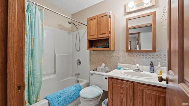 full bathroom with vanity, a textured ceiling, shower / bath combo with shower curtain, toilet, and decorative backsplash