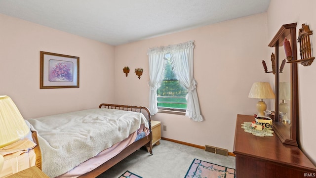 bedroom featuring light carpet