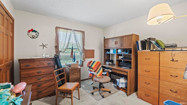 carpeted office space with a textured ceiling