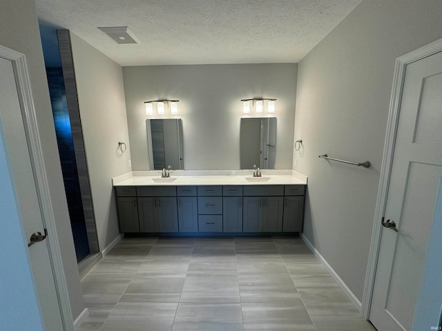 bathroom featuring vanity, a textured ceiling, and tile patterned floors