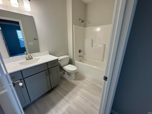 full bathroom featuring tub / shower combination, tile patterned flooring, vanity, and toilet