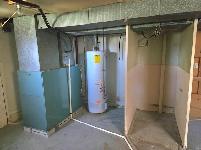 utility room featuring gas water heater and heating unit